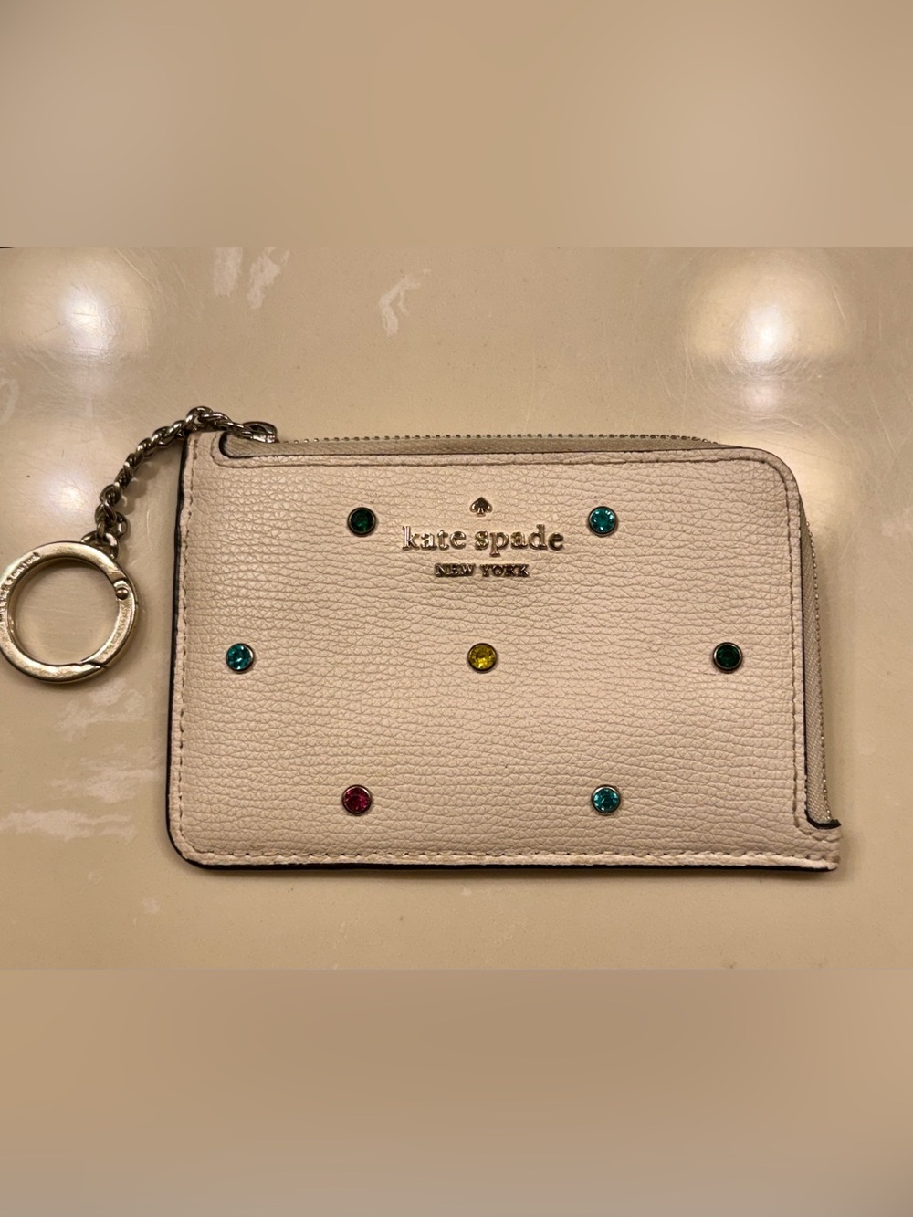kate spade cream leather wristlet with multicolor gem accents